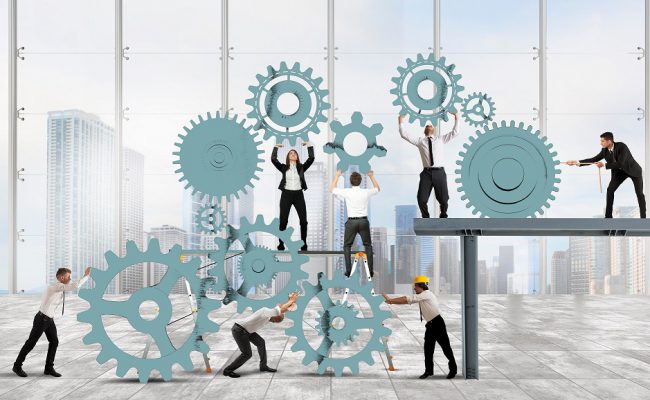 Teamwork of businesspeople work together to a system of gears